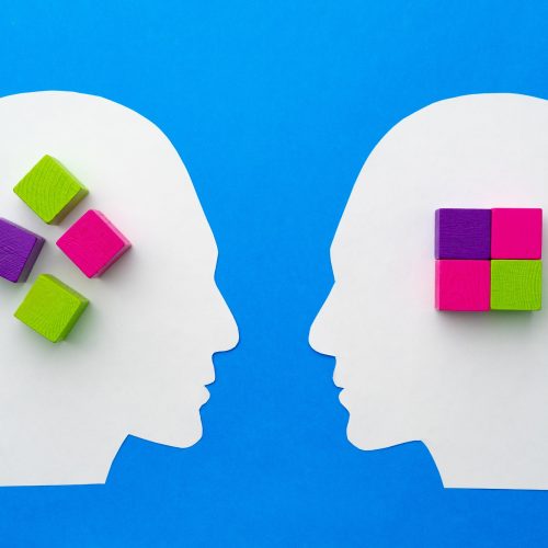Papercut silhouette of human head with colorful constructor pieces